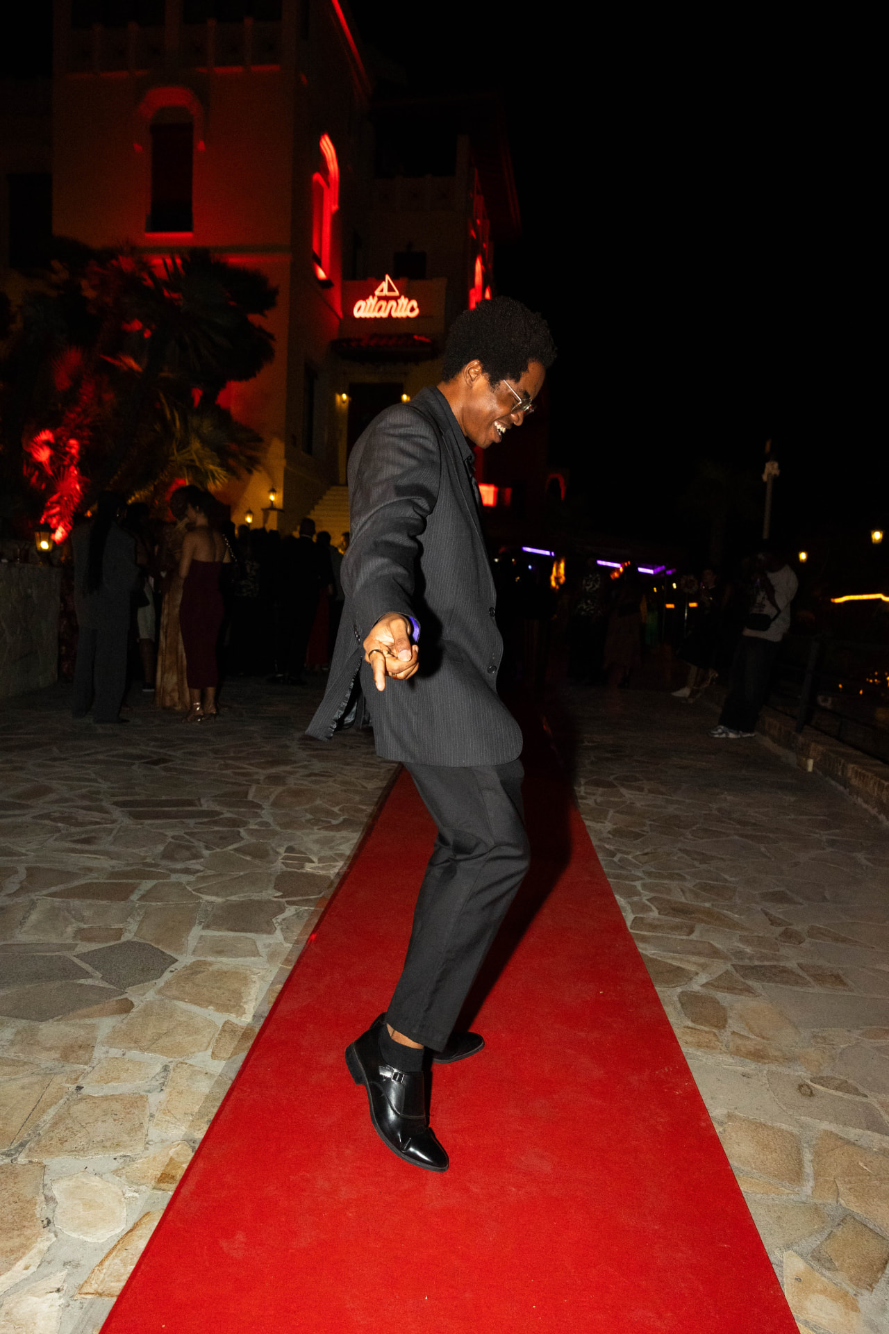 Guest dancing on the red carpet at an African Society event